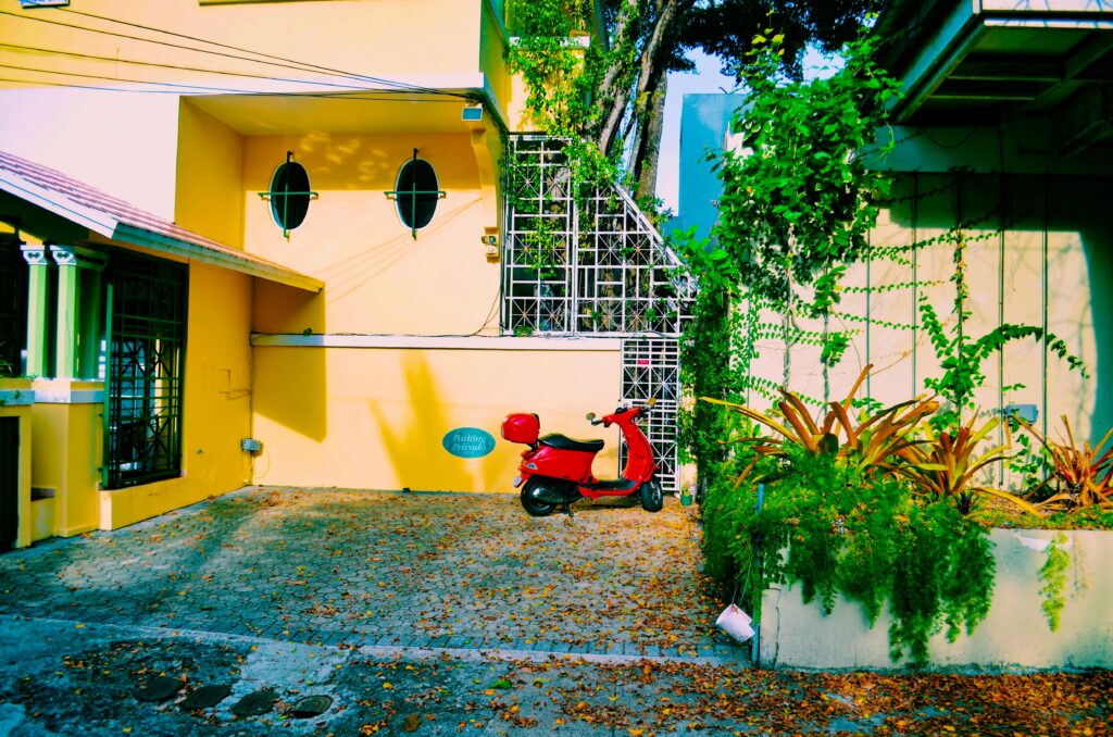 Vibrant urban street scene in San Juan featuring a red scooter against a colorful house facade.